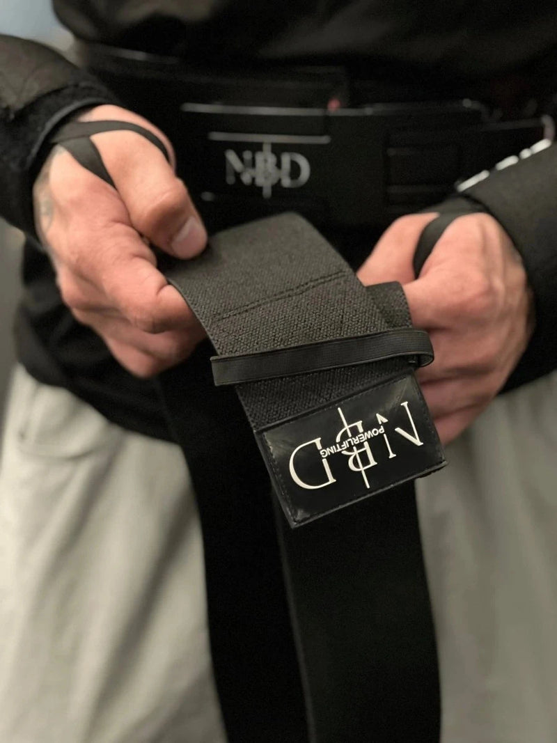 NBD Powerlifter wearing NBD Black Series elbow wraps during bench press training session