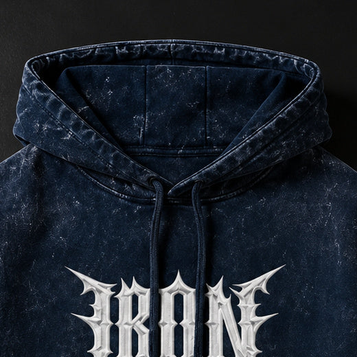 NBD IRON acid wash hoodie — drawcord hood of the navy blue hoodie, above the IRON print