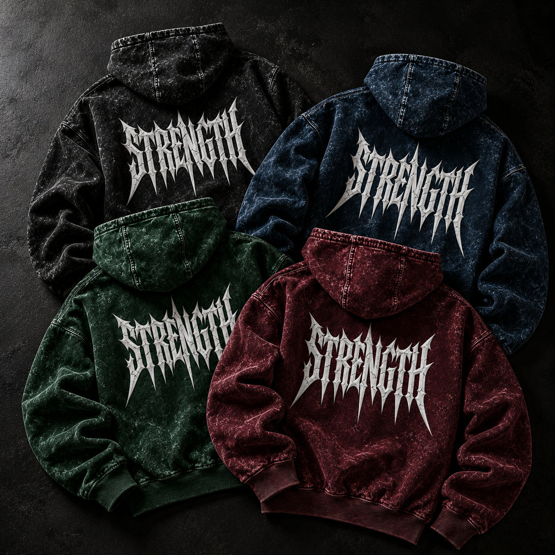 NBD STRENGTH acid wash hoodies in all four colours on a dark studio floor, back print
