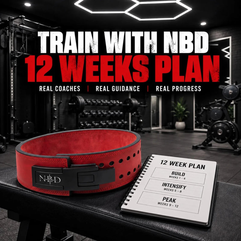TRAIN WITH NBD 12 Week Online Coaching — a red NBD lever belt on a gym bench beside a twelve-week training plan notebook showing build, intensify and peak blocks.