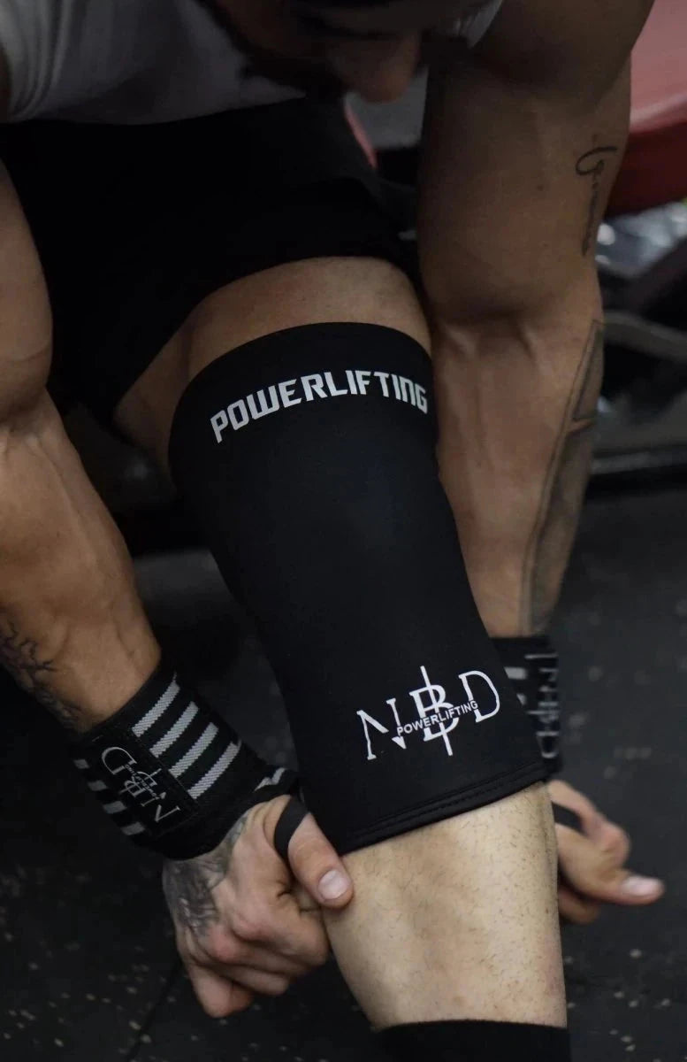 NBD PRO 7mm powerlifting knee sleeves with wrist wraps combo worn by powerlifter during squat training in India
