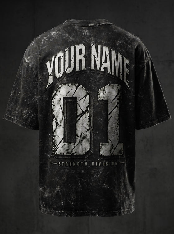 NBD custom name and number oversized tee - studio back view, arched name over cracked-stone 01 and Strength Division on 240 GSM acid wash