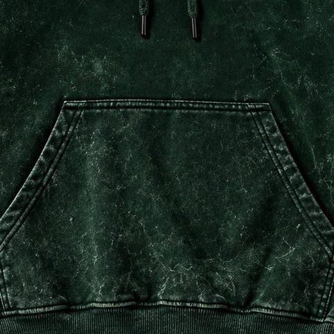 NBD IRON acid wash hoodie in Bottle Green — front close-up, kangaroo pocket and drawcords