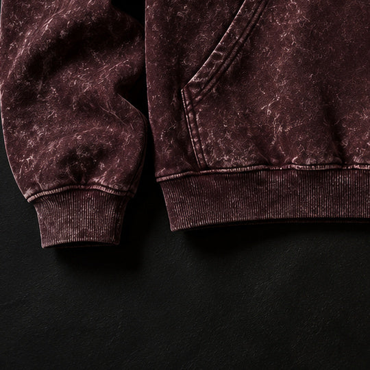 NBD IRON acid wash hoodie — ribbed cuff and hem of the maroon hoodie