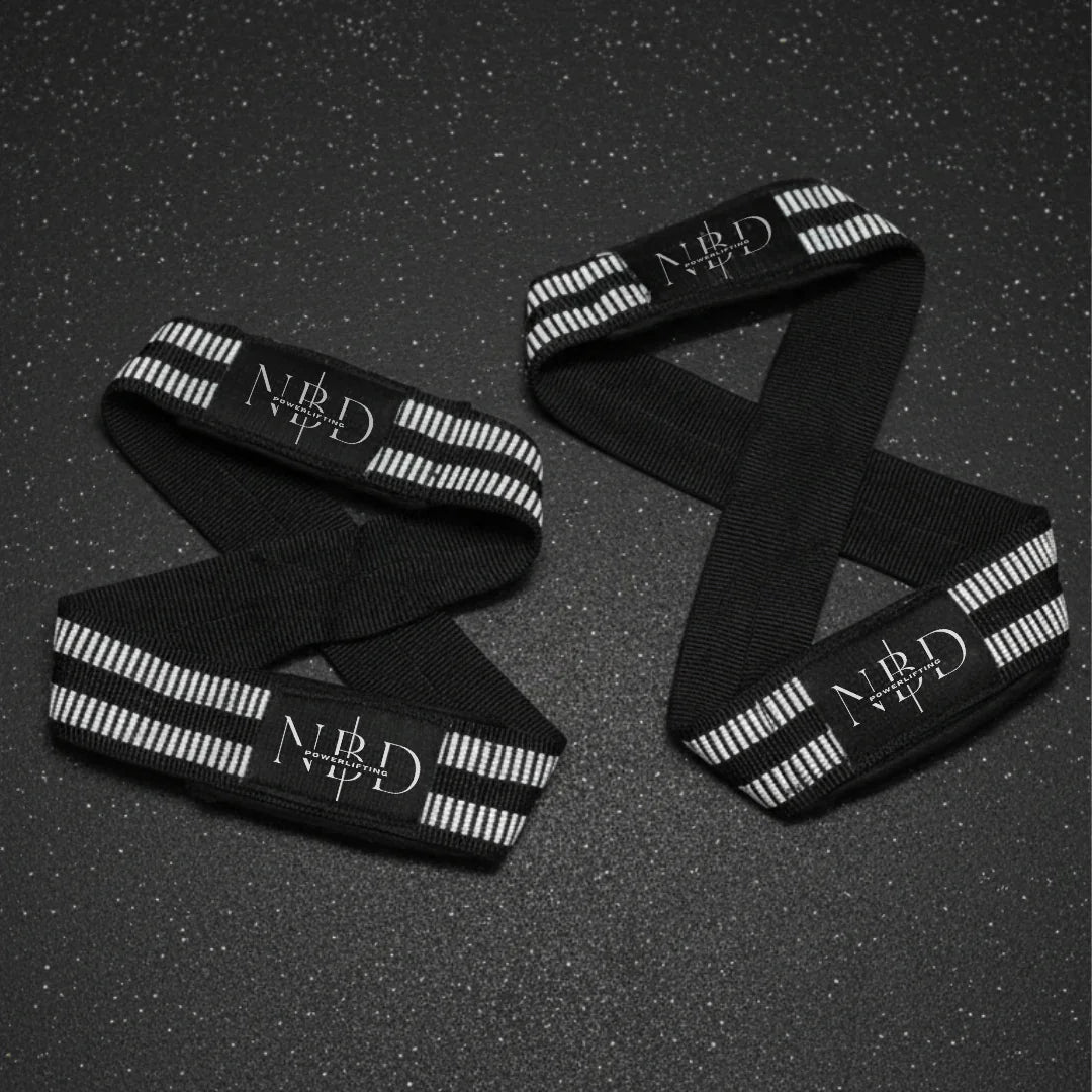 NBD white rubber lifting straps close-up detail showing maximum support grip coating for powerlifting deadlift training