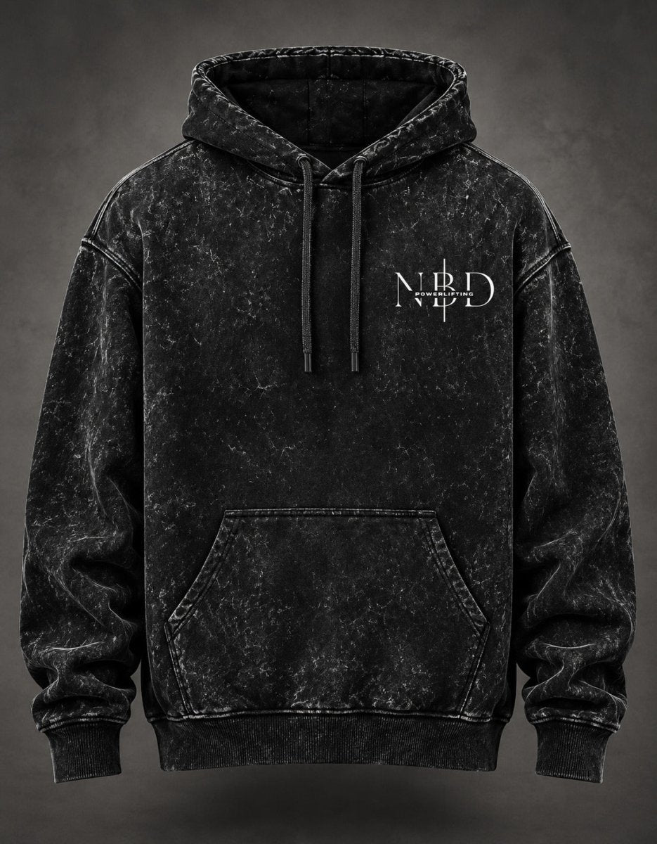NBD POWERLIFTING Crest acid wash hoodie in Black — front view, NBD Powerlifting chest mark, kangaroo pocket and drawcord hood