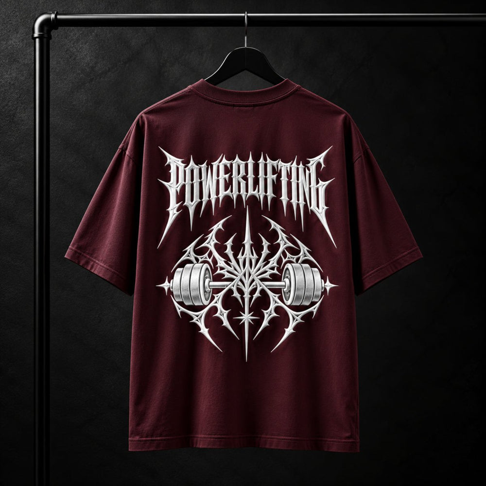 NBD POWERLIFTING Crest oversized T-shirt in Maroon — back view, raised white 3D puff print POWERLIFTING lettering above a barbell crest, studio shot on a hanger