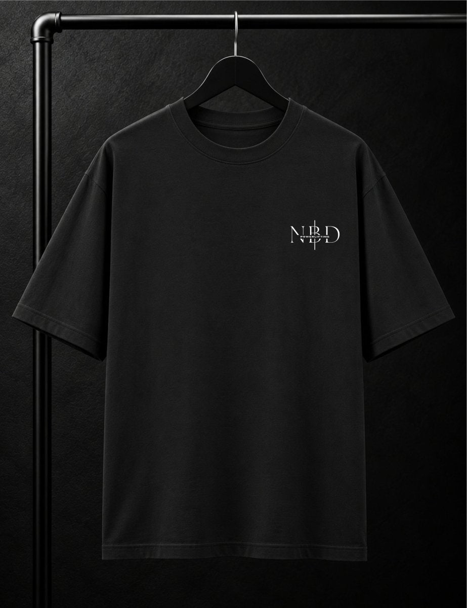 NBD POWERLIFTING Crest oversized T-shirt in Black — front view, ribbed crew neck and small NBD Powerlifting mark on the left chest, studio shot on a hanger