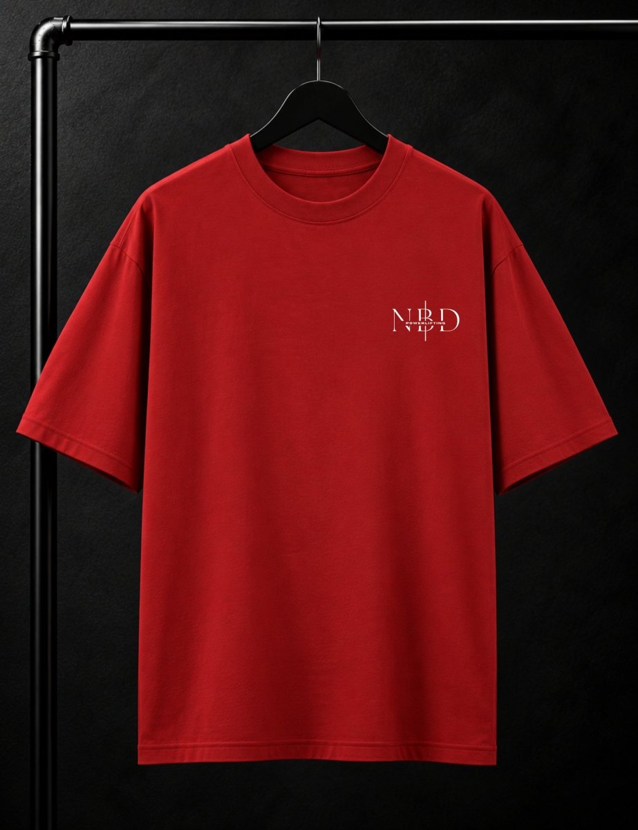 NBD POWERLIFTING Crest oversized T-shirt in Red — front view, ribbed crew neck and small NBD Powerlifting mark on the left chest, studio shot on a hanger