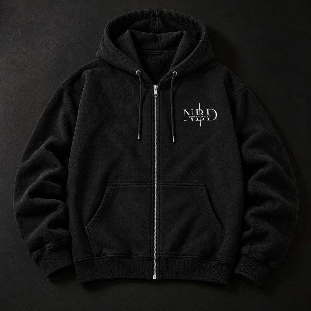 NBD POWERLIFTING Crest zip hoodie in black — front view, full-length zip, drawcord hood and NBD Powerlifting chest logo