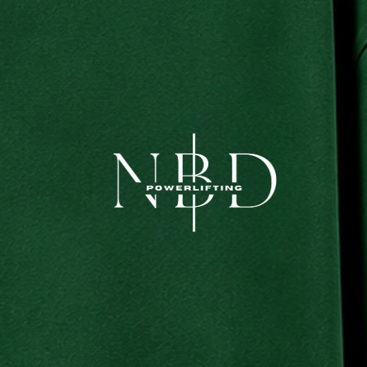 NBD POWERLIFTING Crest oversized T-shirt in Bottle Green — chest close-up, NBD Powerlifting mark on the left chest