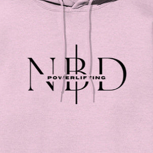 NBD SIGNATURE logo hoodie in Light Baby Pink — chest close-up of the NBD Powerlifting monogram print