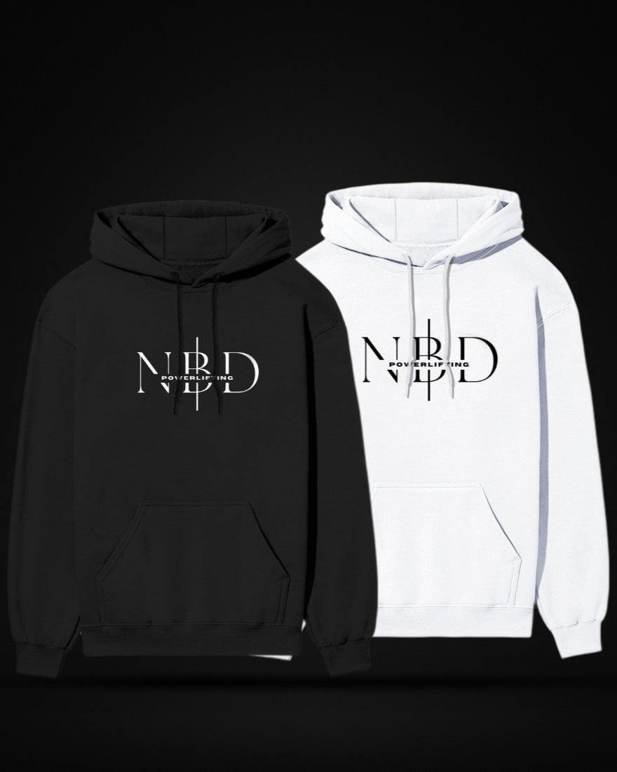 Two NBD SIGNATURE logo hoodies side by side — the NBD Powerlifting monogram printed light on a dark hoodie and dark on a light hoodie