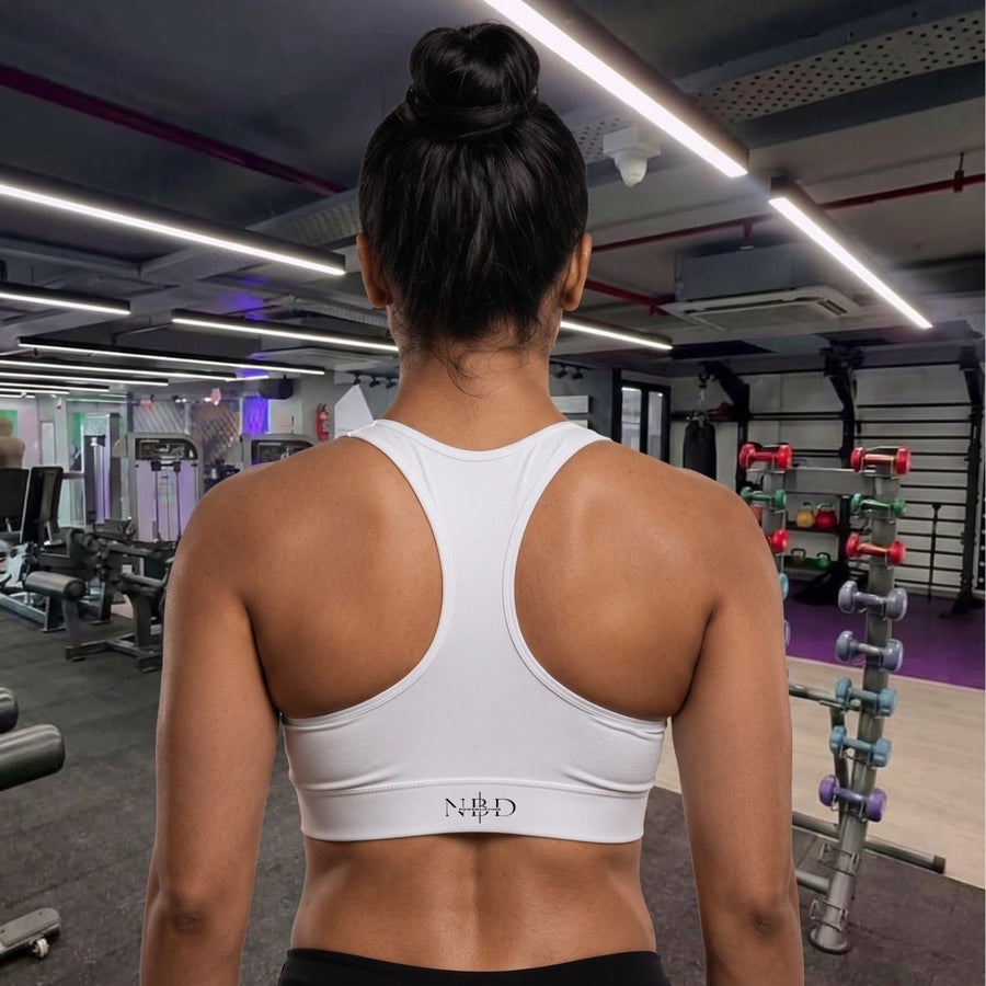 NBD high-performance sports bra - back view showing racerback construction and support, white workout bra for women